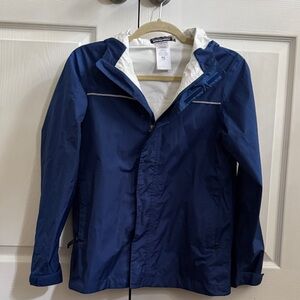 Patagonia blue rain jacket with hood and reflective stripe